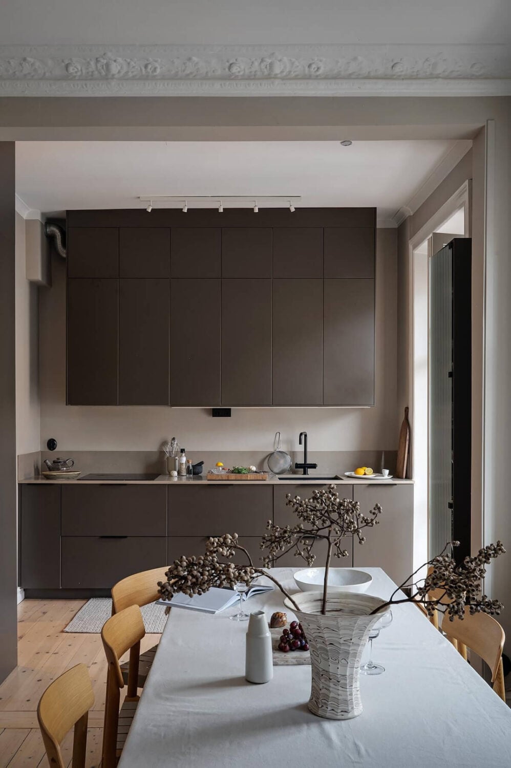 A Gothenburg Apartment with a Small Dark Green Bedroom 13 wide doorway stucco black kitchen