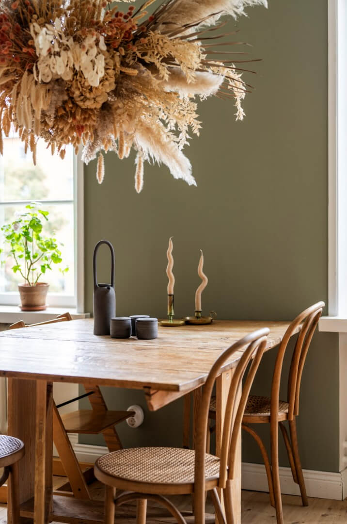 A Light Swedish Apartment with a Green Living Room 10 wooden dining table