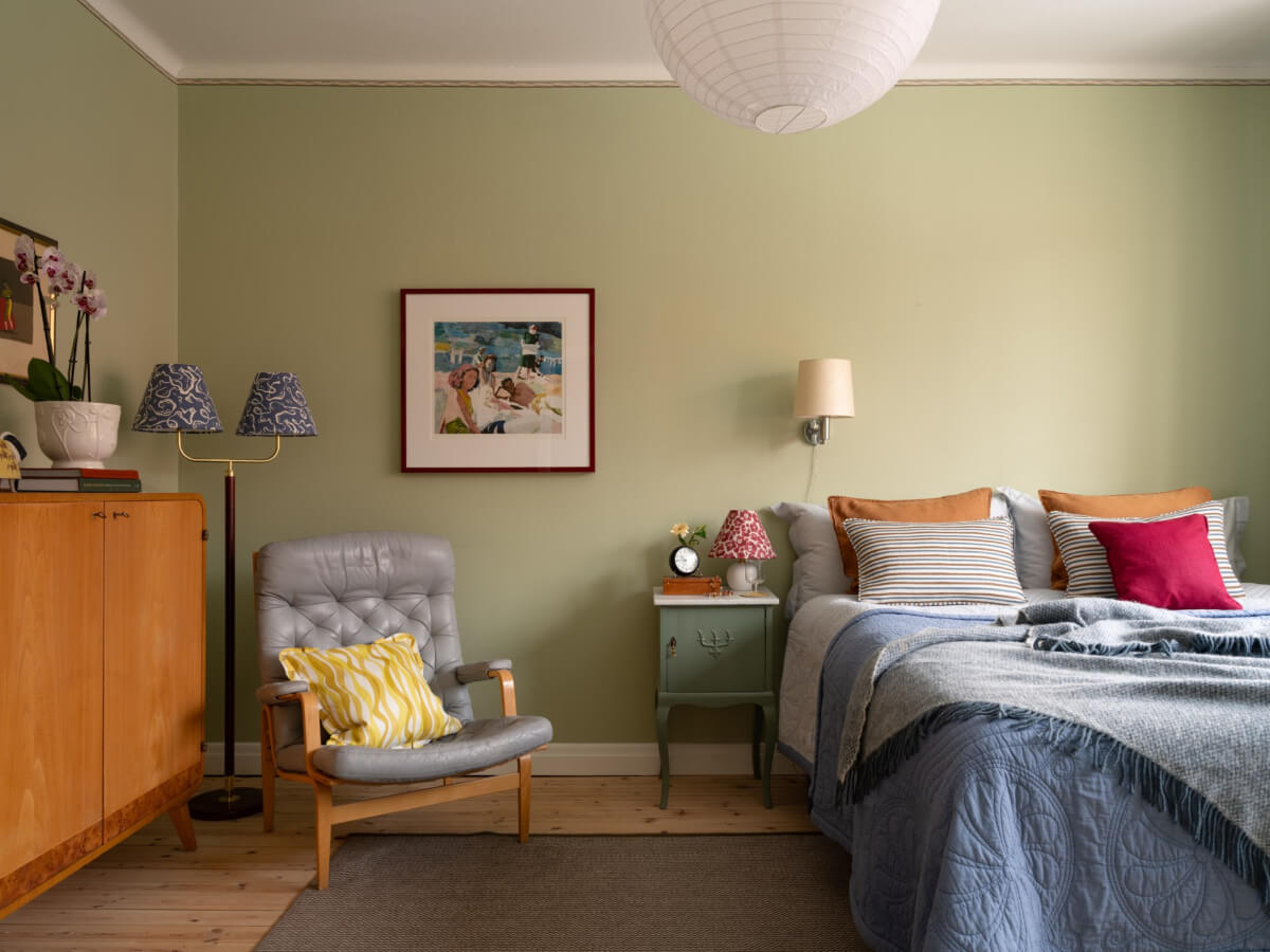 A Beautiful Well-Preserved 1930s Apartment with a Blue Kitchen 14 wooden floorboards green walls bedroom