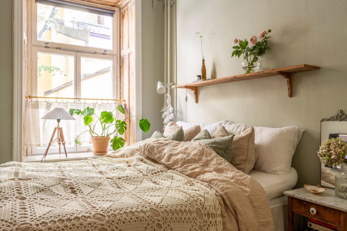 A Cozy Small Apartment with Period Features and Lots of Storage 19 wooden shelf above bed