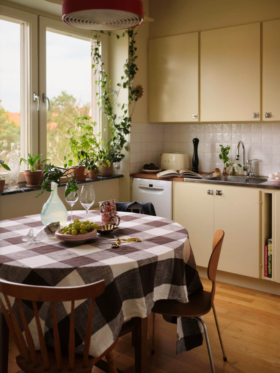 A 1940s Swedish Apartment with a Soft Yellow Kitchen 9 yellow kitchen with dining table