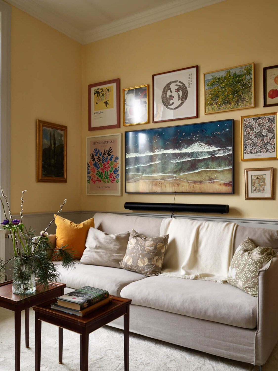 Lovely Color Combinations in a Charming One-Bedroom Apartment 3 yellow living room gallery walls