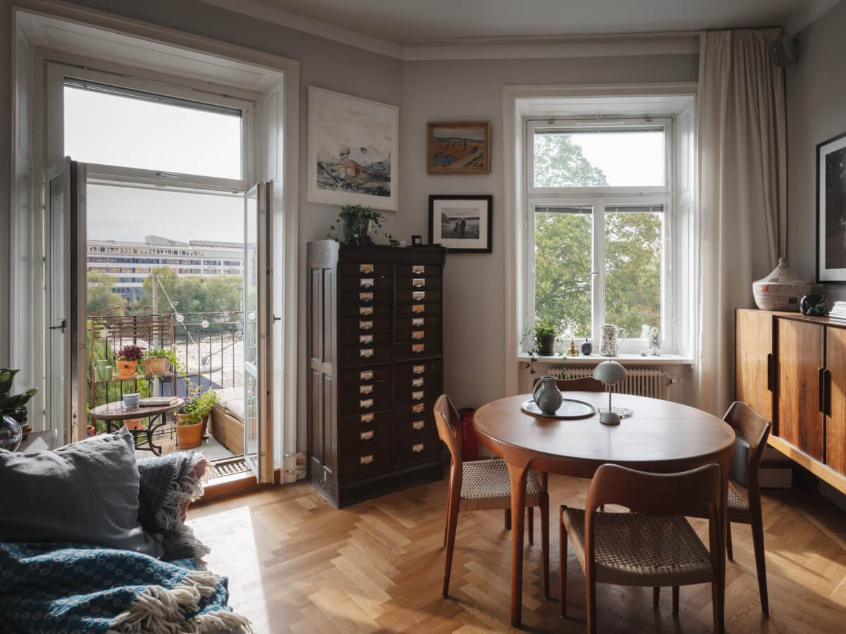 Gray Tones and Built-in Storage in a Charming Corner Apartment 2 angled walls living room gray paint parquet floor