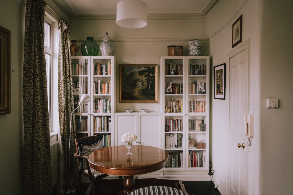 A Carefully Restored Edwardian Apartment with a Garden 5 antique table and bookcases