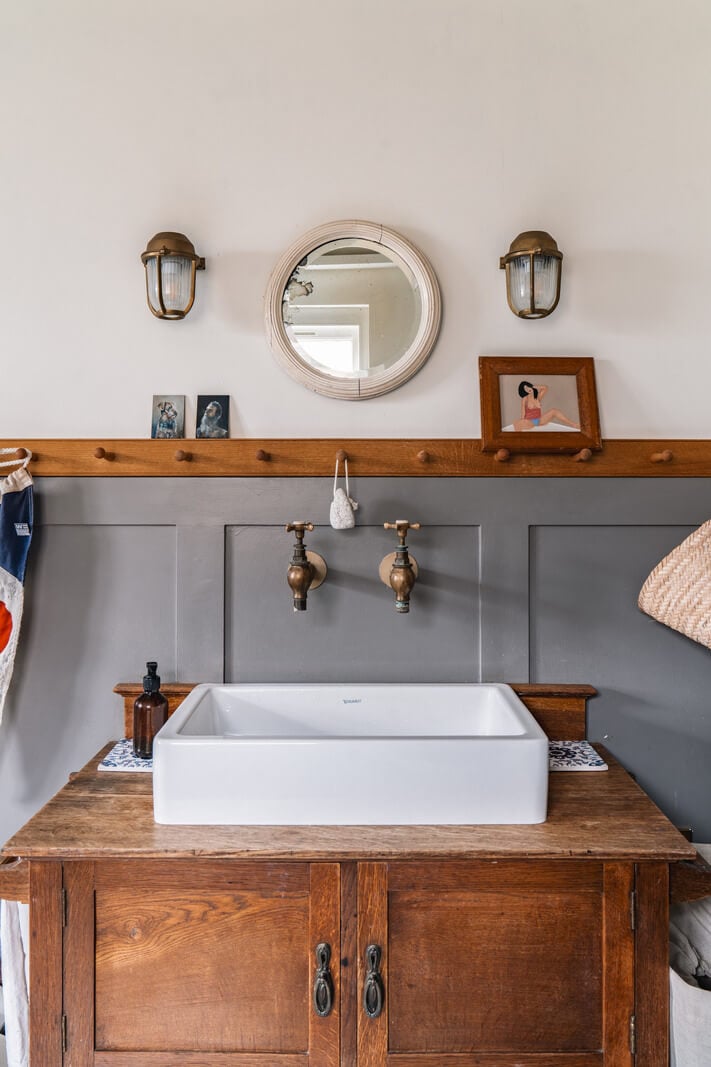A Cozy Victorian Home Painted in Moody Blue and Gray Tones 31 antique vanity bathroom