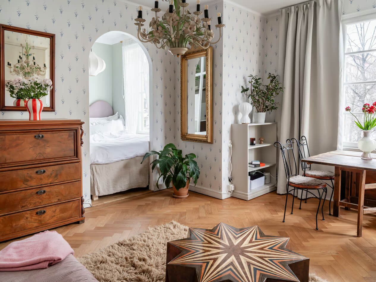 A Charming Small Apartment with a Cozy Bedroom Niche 4 apartment parquet floor blue wallpaper arched doorway to bedroom
