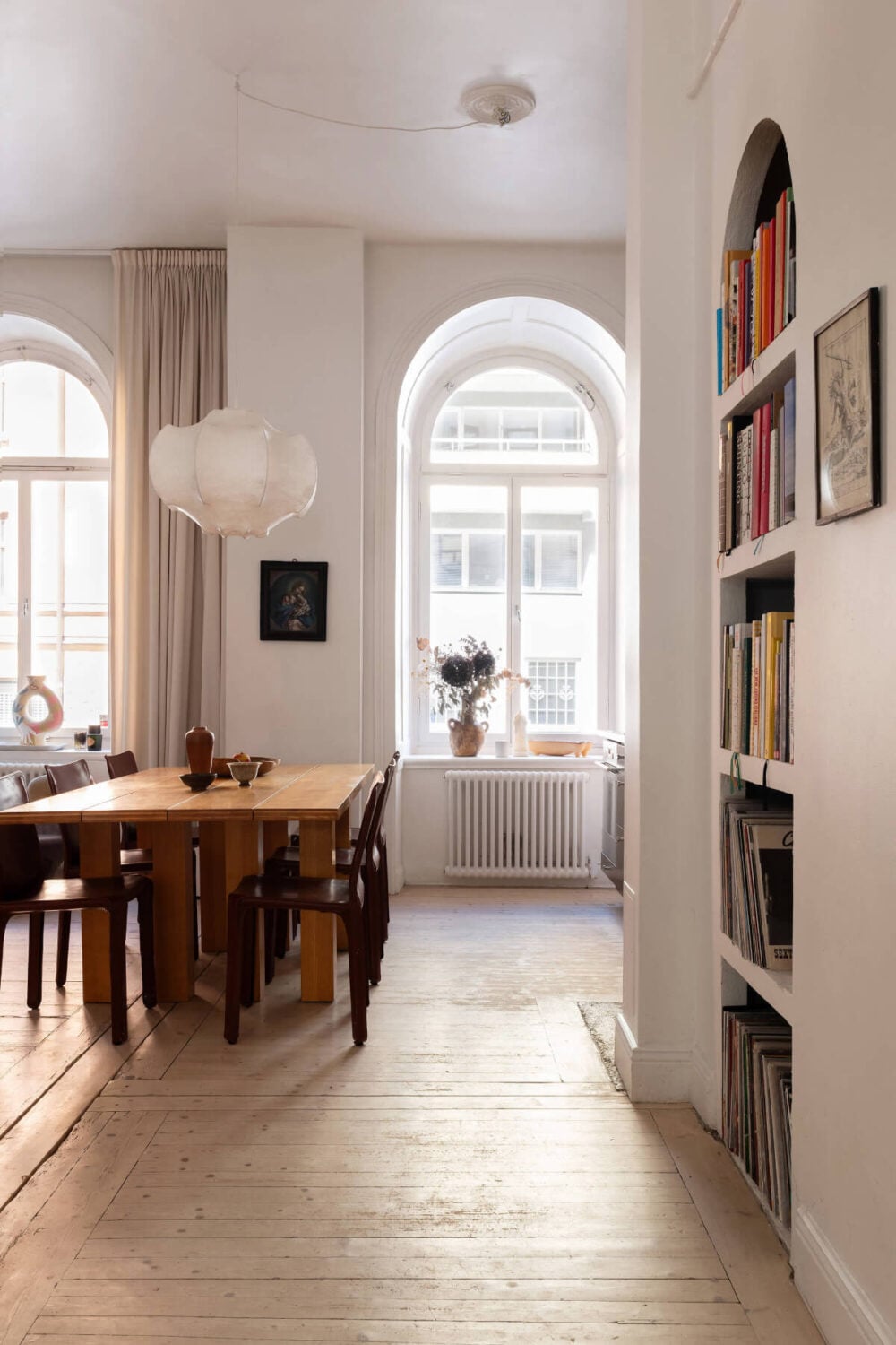 Arches and a Wall Mural in a Swedish Apartment 12 arched windows built-in bookshelves niche