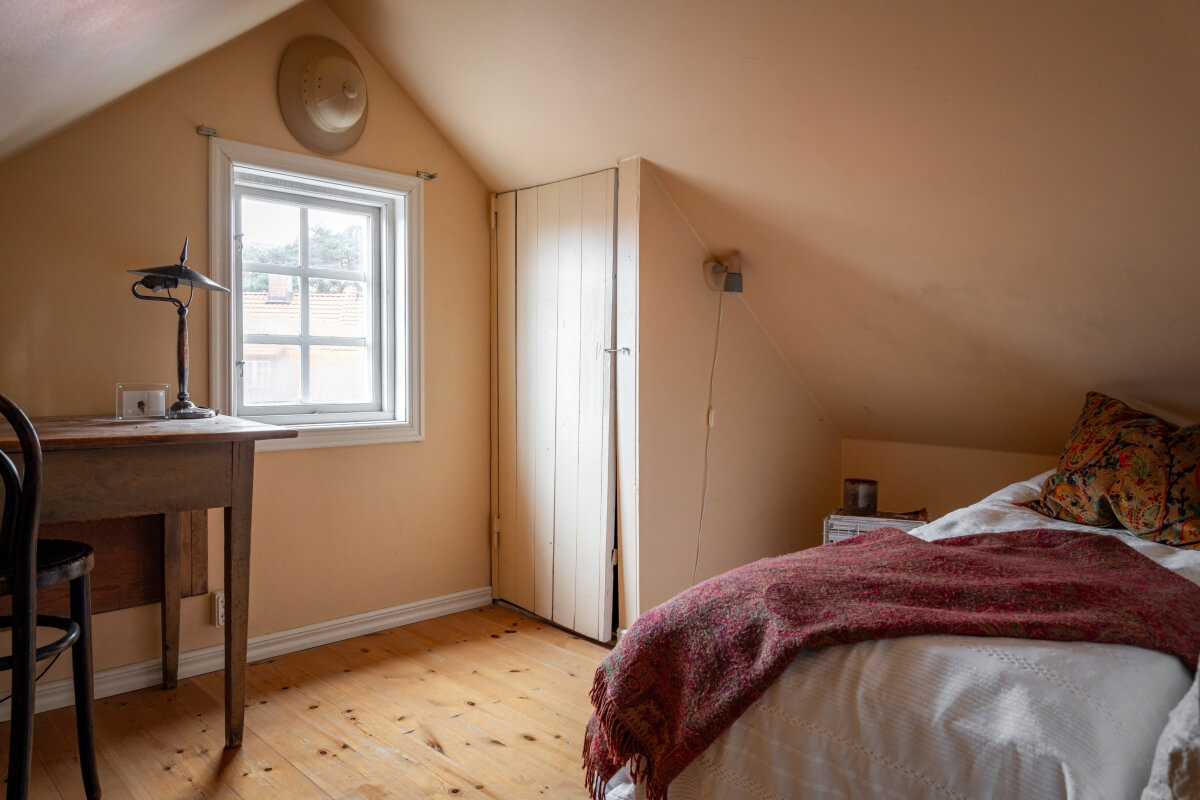 Turn-of-the-Century Charm Meets Modern Comfort in a Swedish House 26 attic room wooden desk