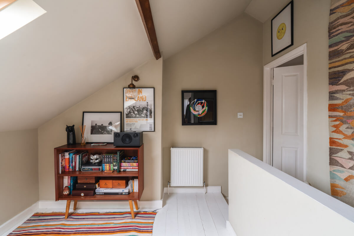 A Cozy Two-Bedroom Attic Apartment in a Victorian Townhouse 14 attic space colorful rug white floorboards