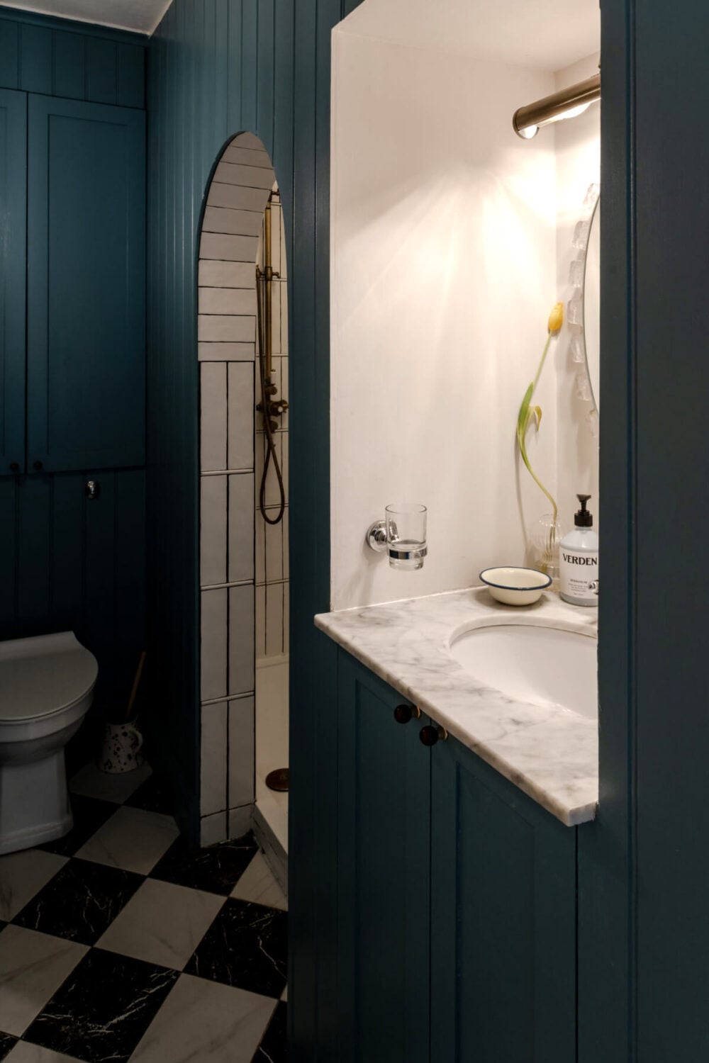 Color, Pattern, and Textures in a Renovated London Townhouse 16 bathroom blue paneling checkerboard floor arched shower doorway nordroom