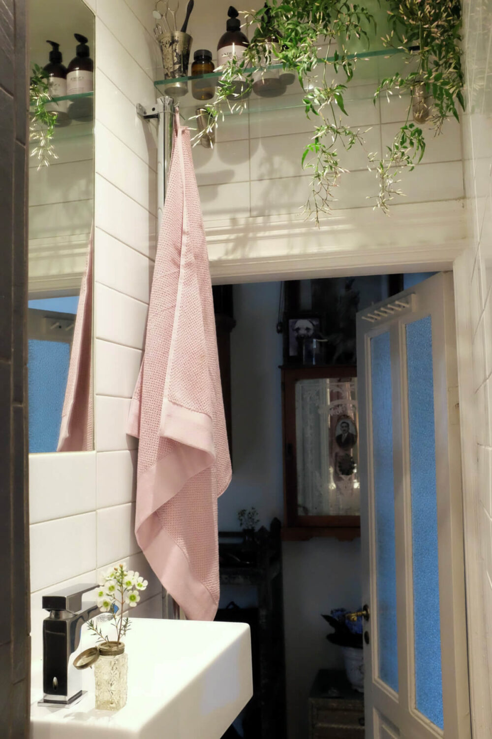 Time Has Stood Still in This Stockholm Studio Apartment 23 bathroom glass shelf above door