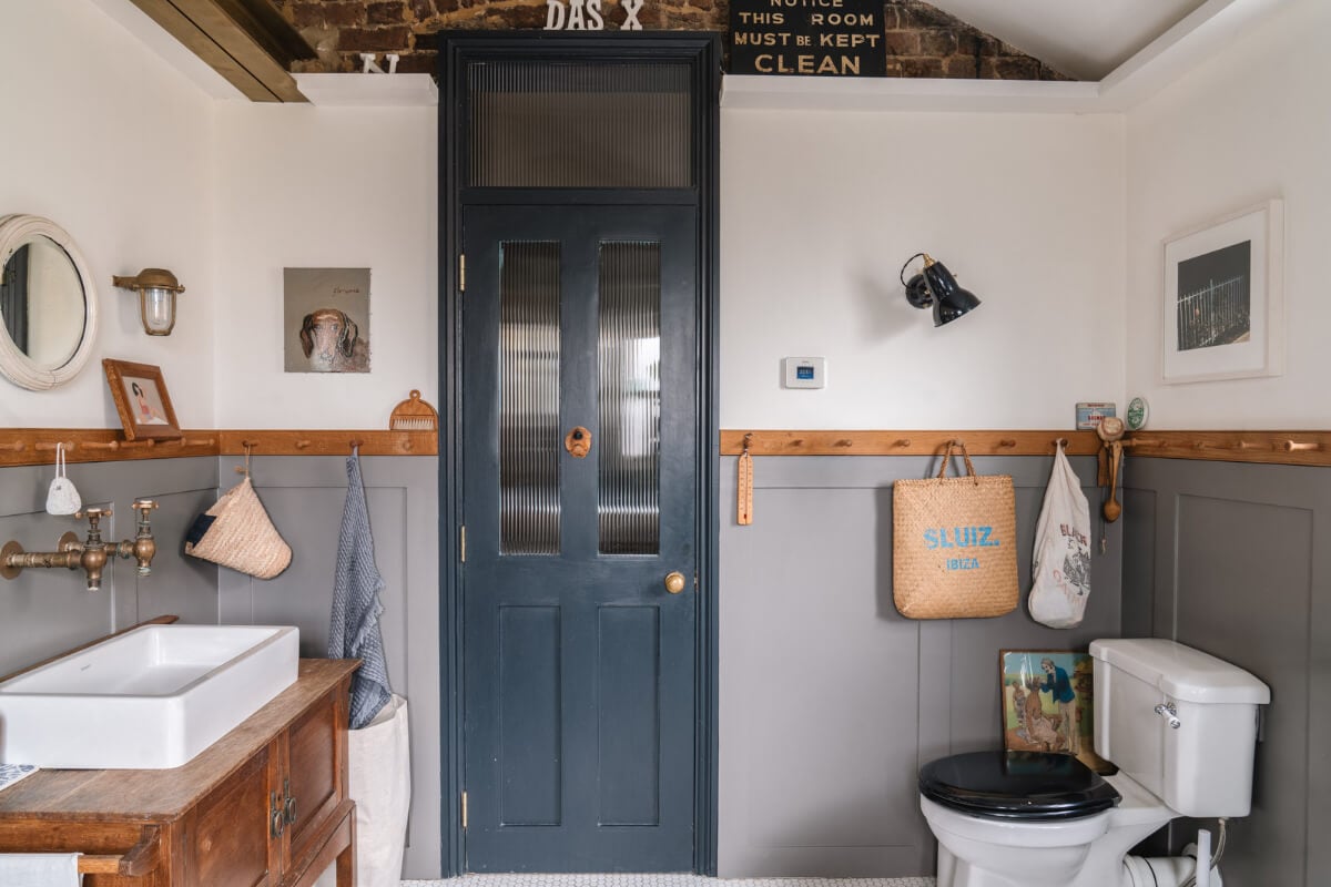 A Cozy Victorian Home Painted in Moody Blue and Gray Tones 30 bathroom gray paneling antique bathroom vanity