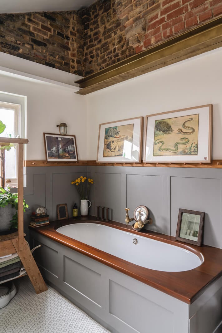 A Cozy Victorian Home Painted in Moody Blue and Gray Tones 28 bathroom with bath and exposed brick nordroom