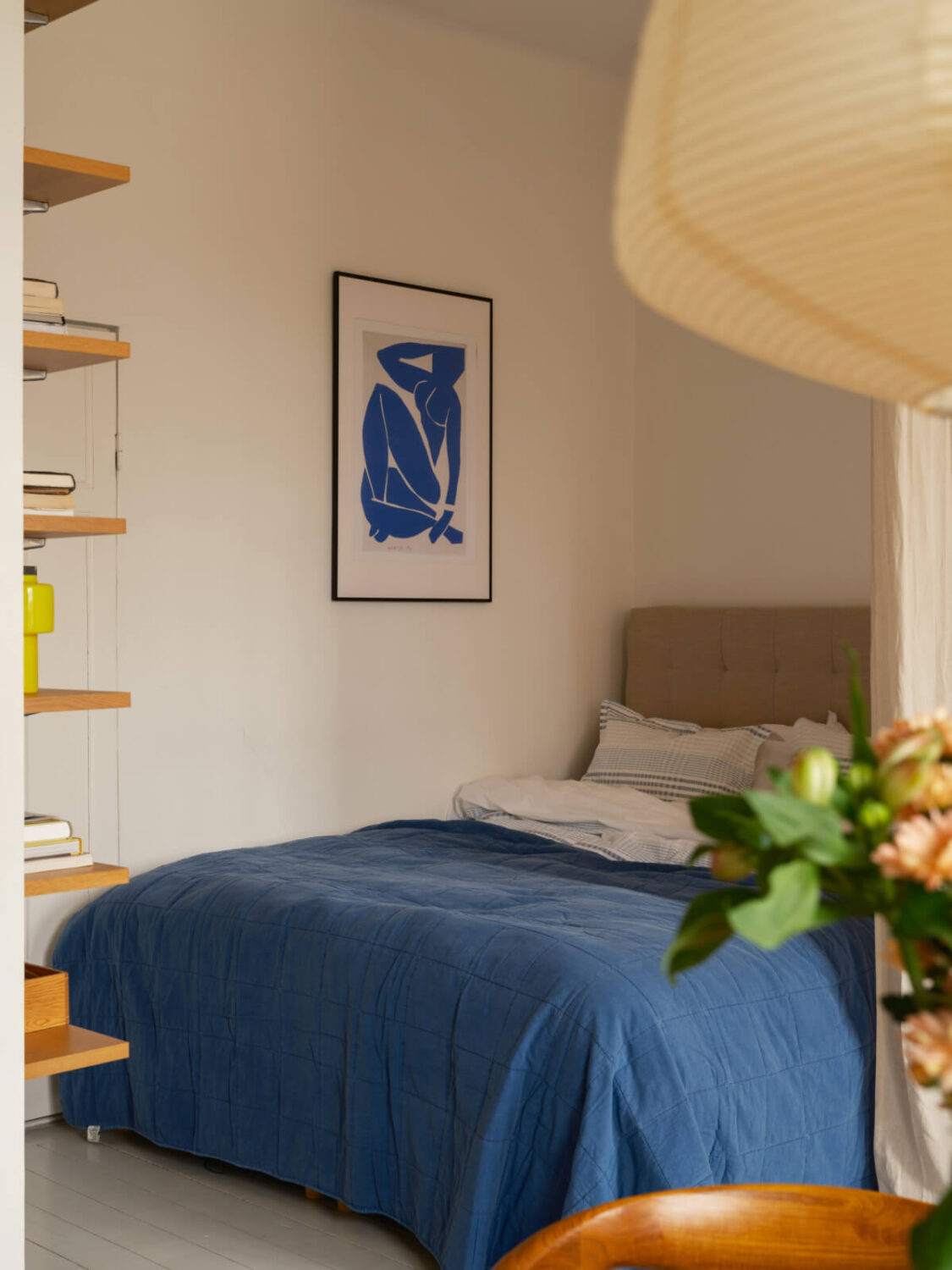 A Studio Apartment with an Exposed Brick Wall 10 bed nook blue beddding