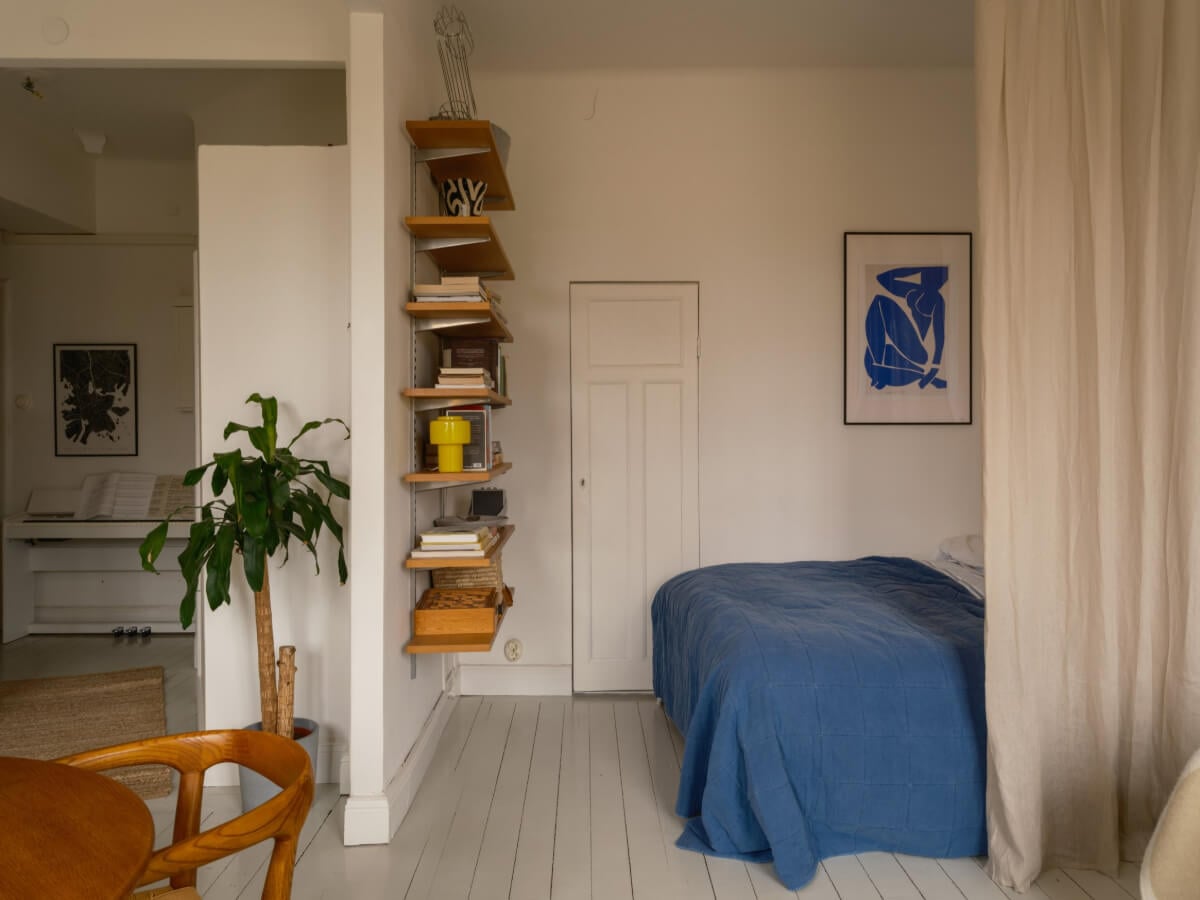 A Studio Apartment with an Exposed Brick Wall 11 bed nook with bookshelves