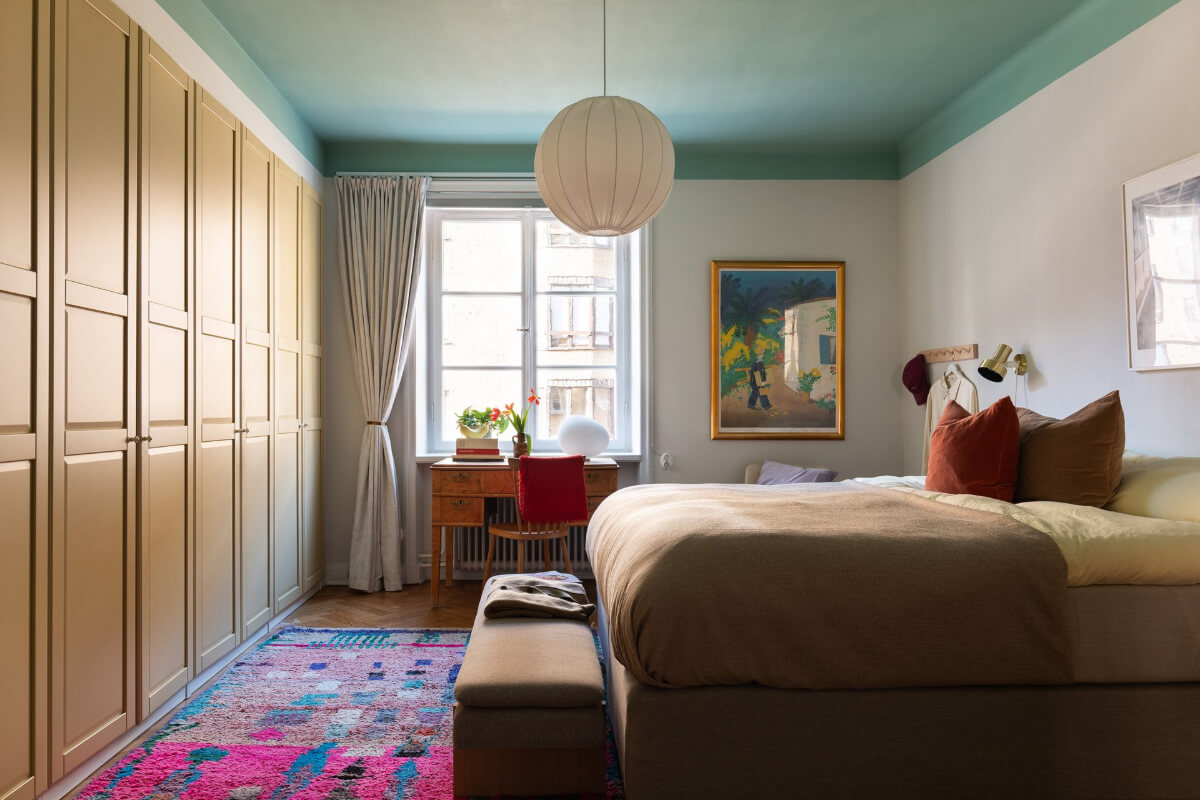 A Swedish Apartment with Period Features and Charming Color Pops 21 bedroom green ceiling ochre built-in wardrobes