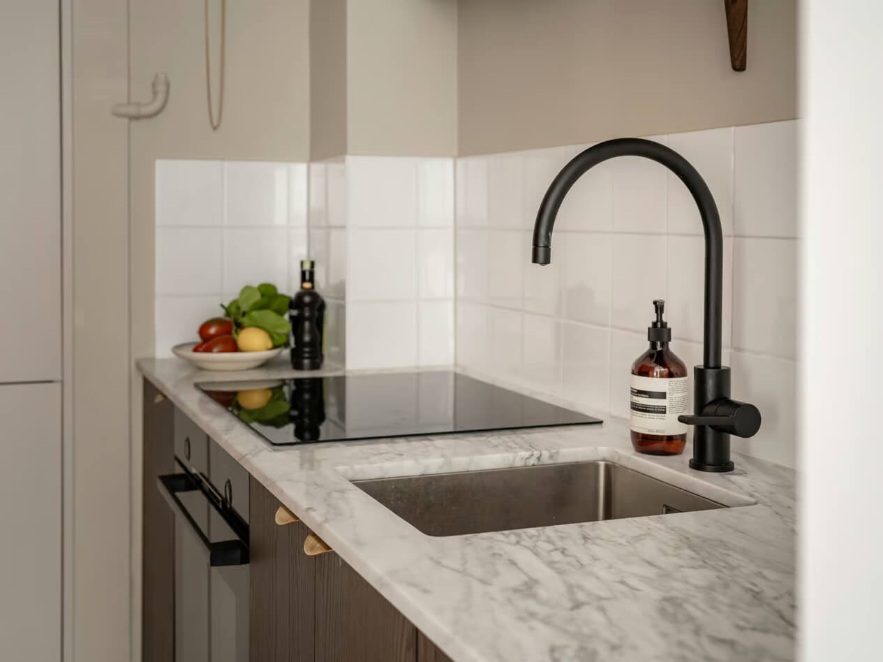 A Charming Small Apartment with a Cozy Bedroom Niche 12 black faucet kitchen