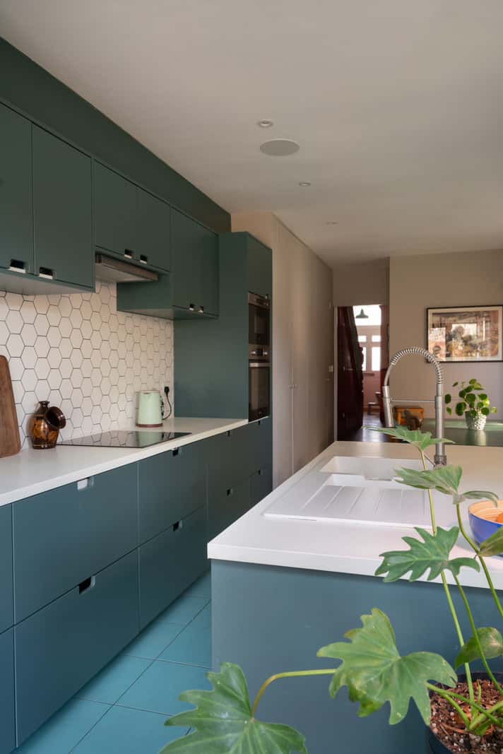A Colorful Home with a Gold Extension in North London 5 blue kitchen hexagon white backsplash tiles