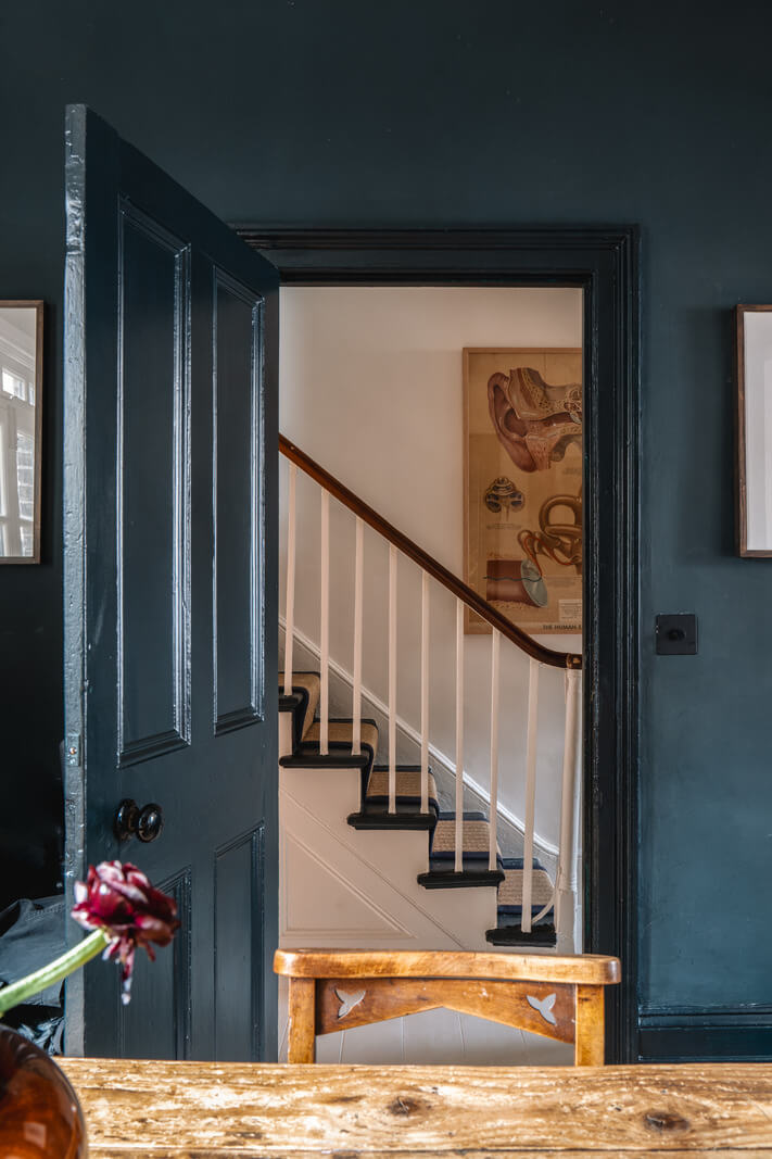 A Cozy Victorian Home Painted in Moody Blue and Gray Tones 8 blue-painted door