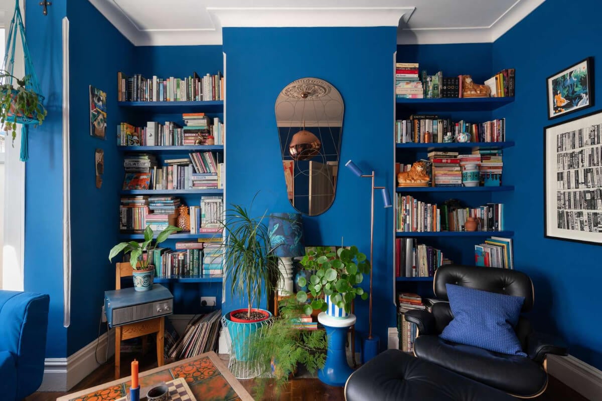 A Colorful Home with a Gold Extension in North London 10 blue sitting room with bookshelves
