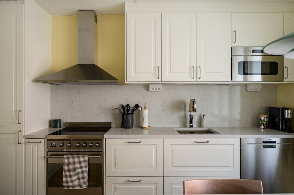 Colorful Rooms in a Bright Two-Bedroom Stockholm Apartment 11 classic white kitchen