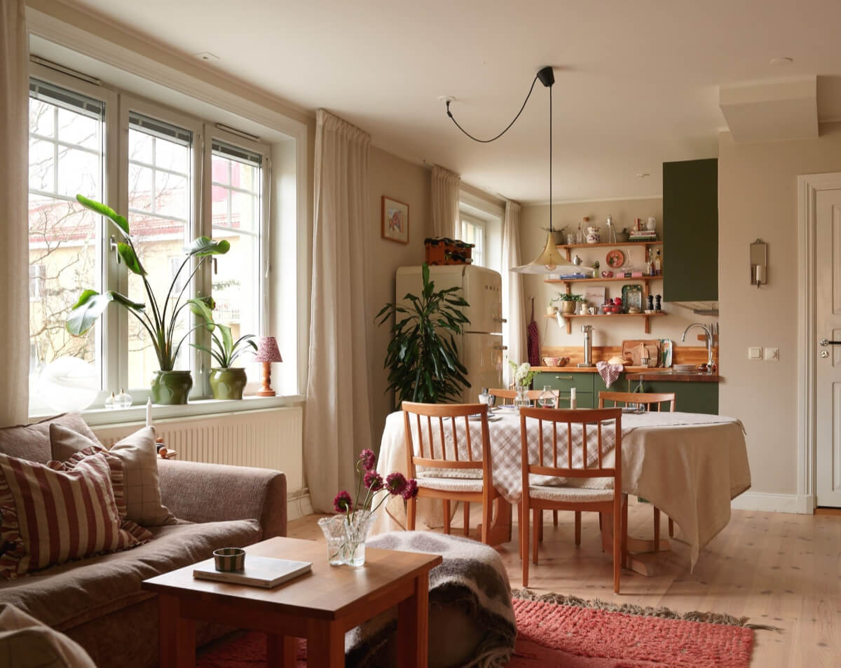 cozy open plan living space green kitchen