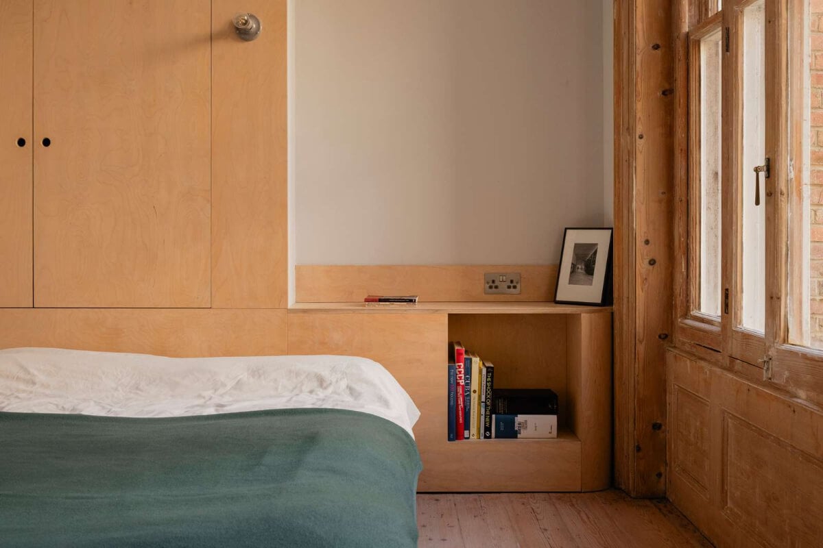 Bespoke Furniture in a Restored Seaside Apartment in England 17 custom birch ply headboard with wardrobes