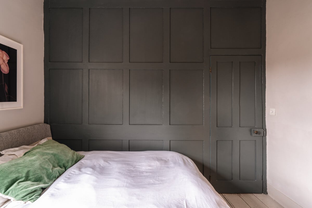 A Cozy Victorian Home Painted in Moody Blue and Gray Tones 24 dark gray paneled wall
