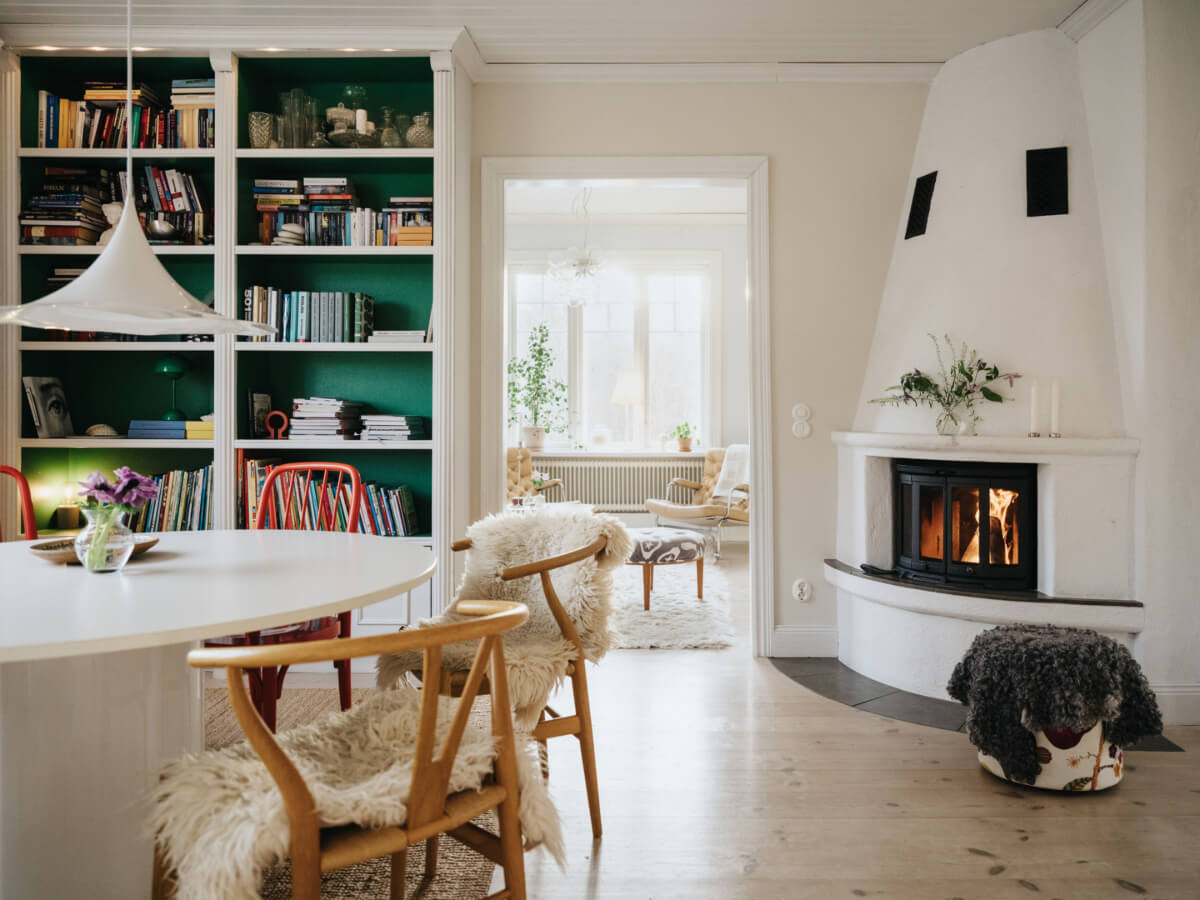 Light-Filled Rooms in a Charming 1907 Swedish Villa 12 dining room built-in bookshelves green interior