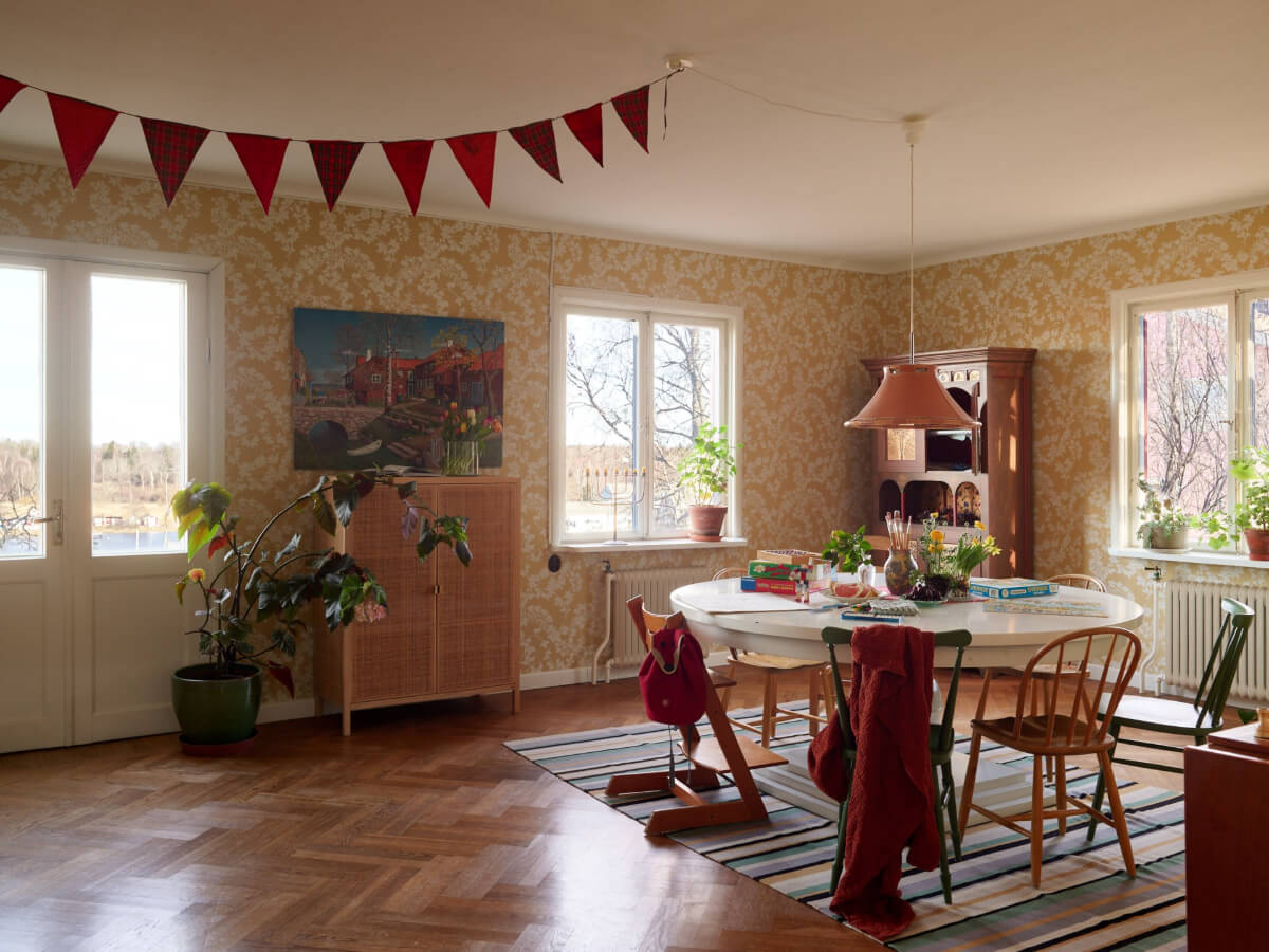 A Grand Family Home in a Former Swedish Doctor's Villa 11 dining room golden yellow wallpapaer