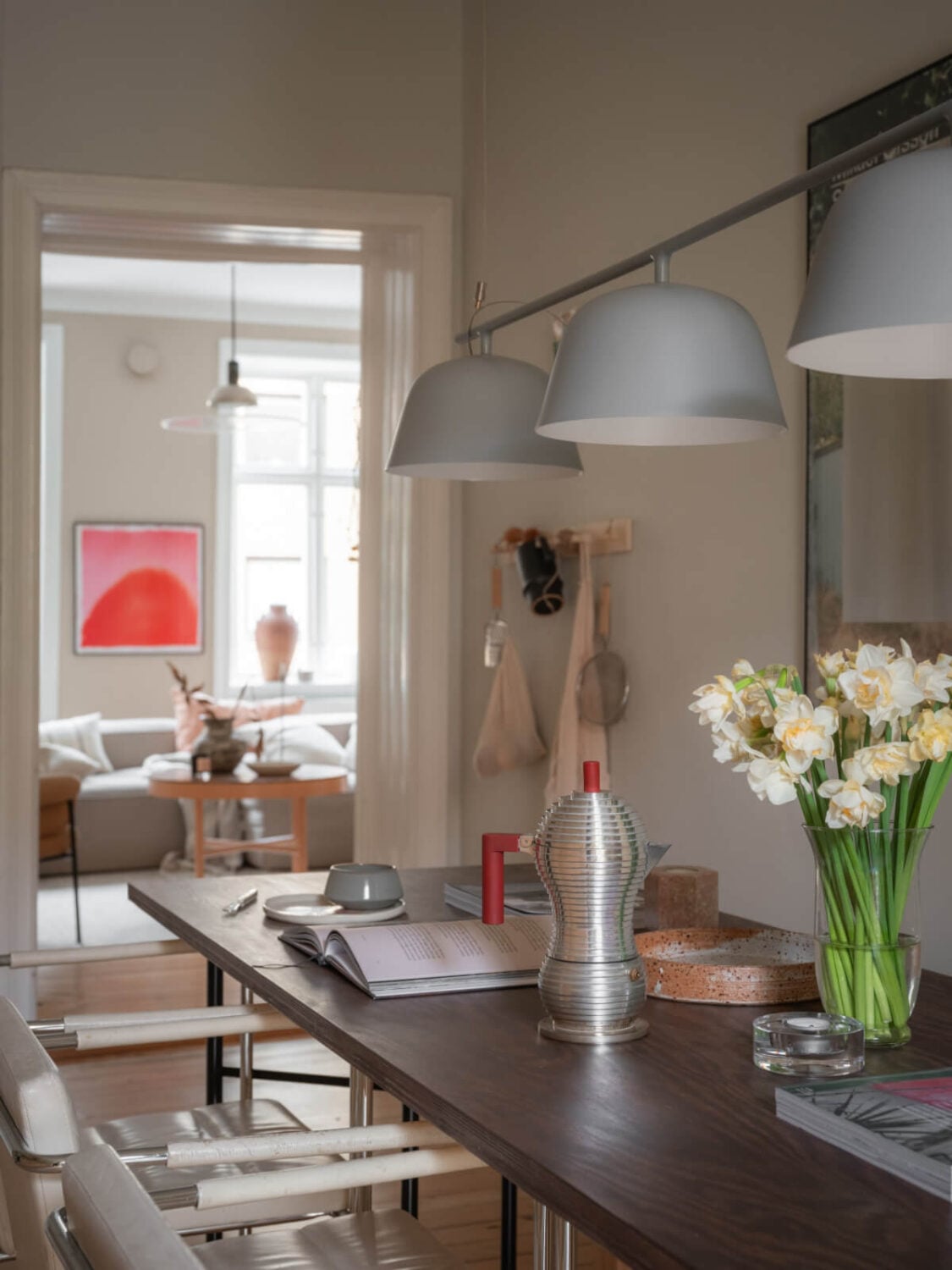 A Calm Color Palette in a Charming Swedish Apartment 16 dining table gray pendants