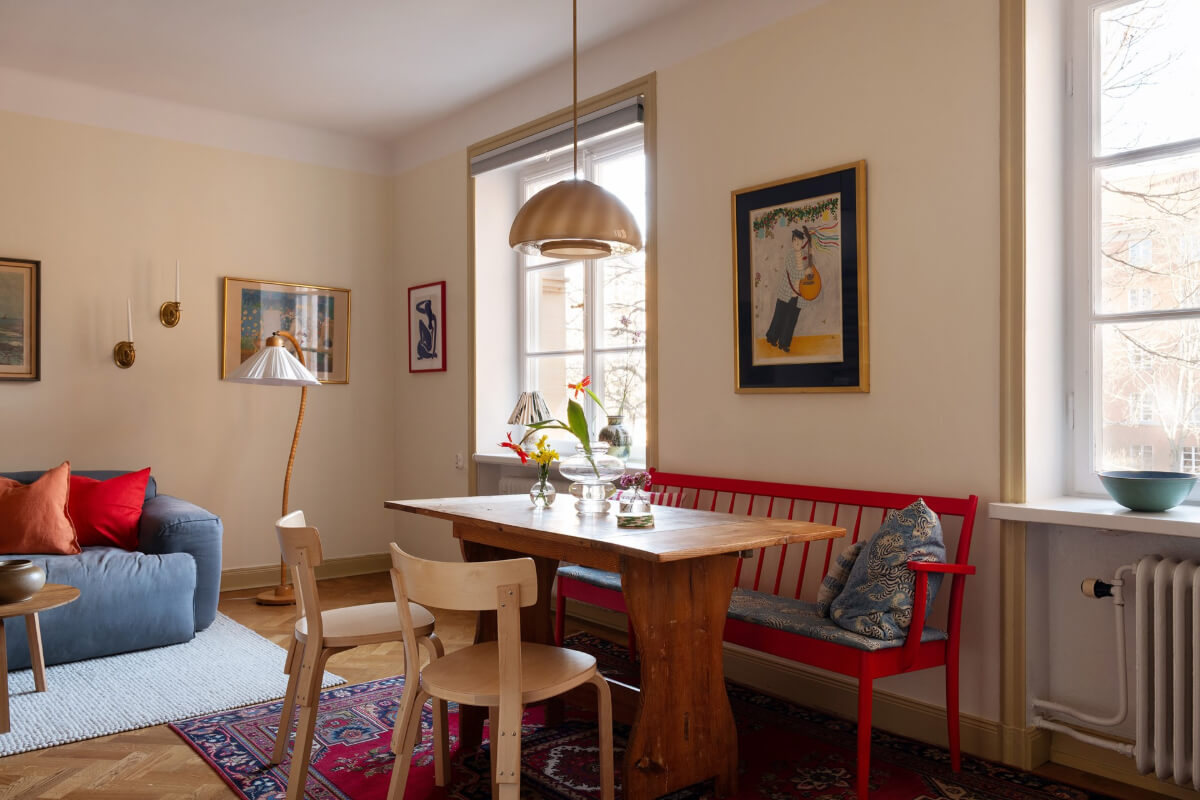 A Swedish Apartment with Period Features and Charming Color Pops 7 dining table red bench