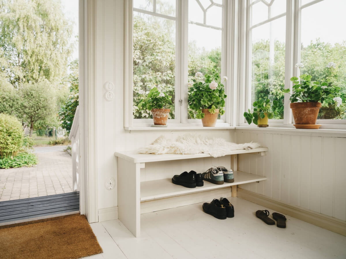 Light-Filled Rooms in a Charming 1907 Swedish Villa 6 entry hall white floor shoe shelves