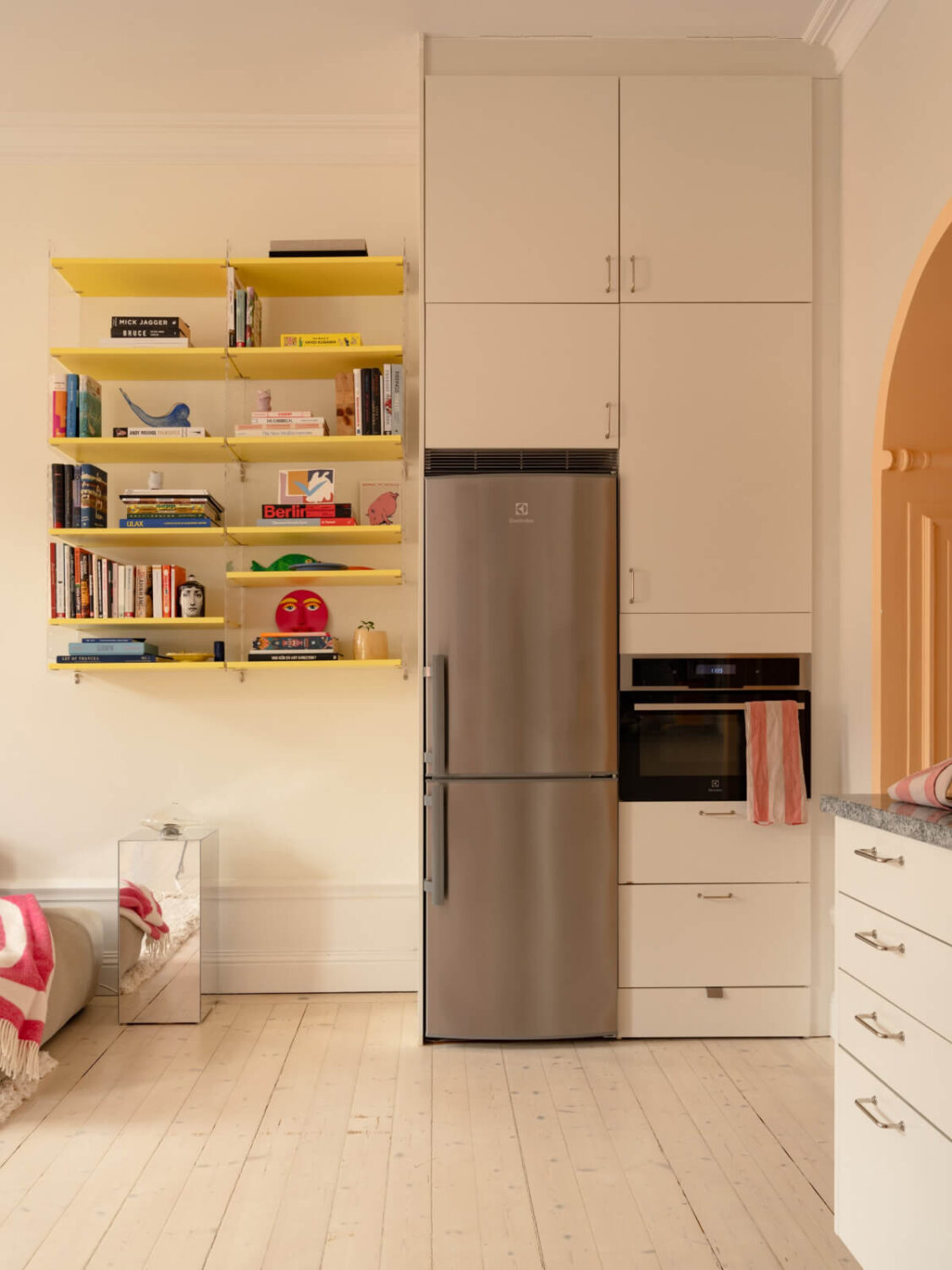 Cheerful Color Accents in a One-Bedroom Stockholm Apartment 10 floor to ceiling kitchen cabinets yellow shelves