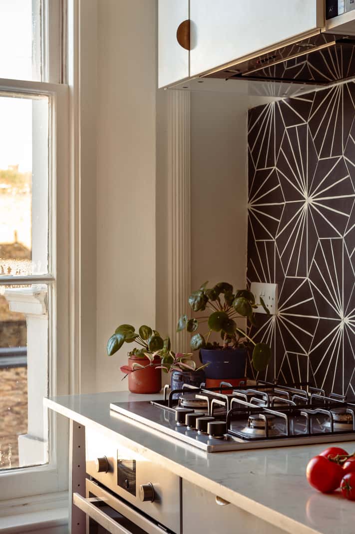 A Corner Apartment with Large Windows in a Former London Pub 7 geometric backsplash white kitchen
