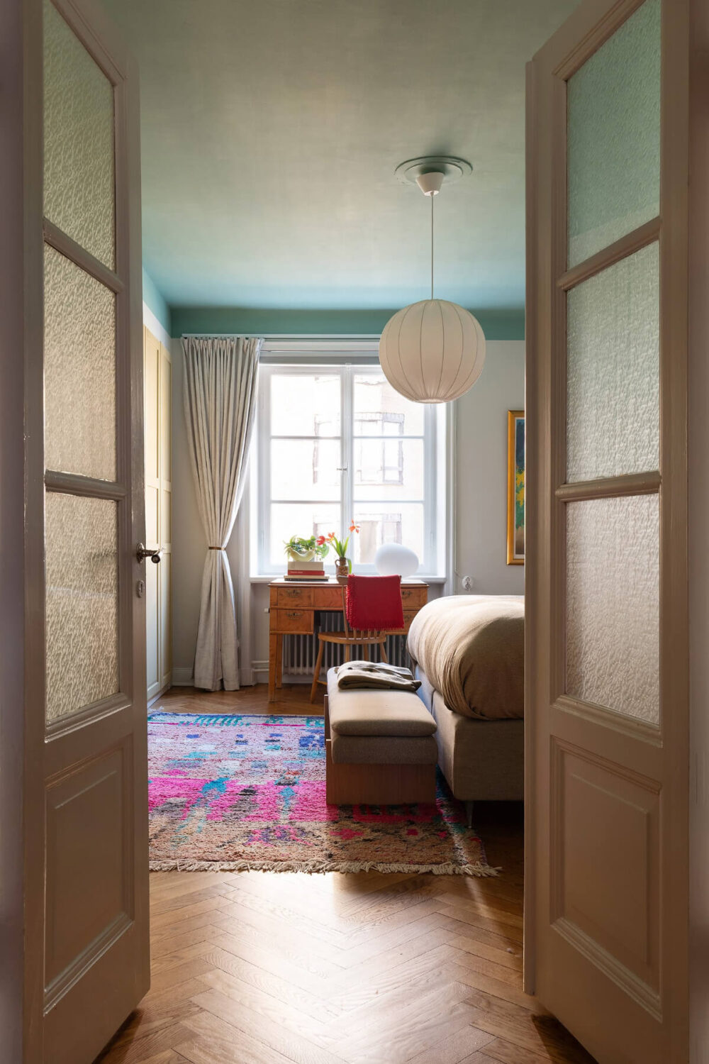 A Swedish Apartment with Period Features and Charming Color Pops 19 glass doors to bedroom