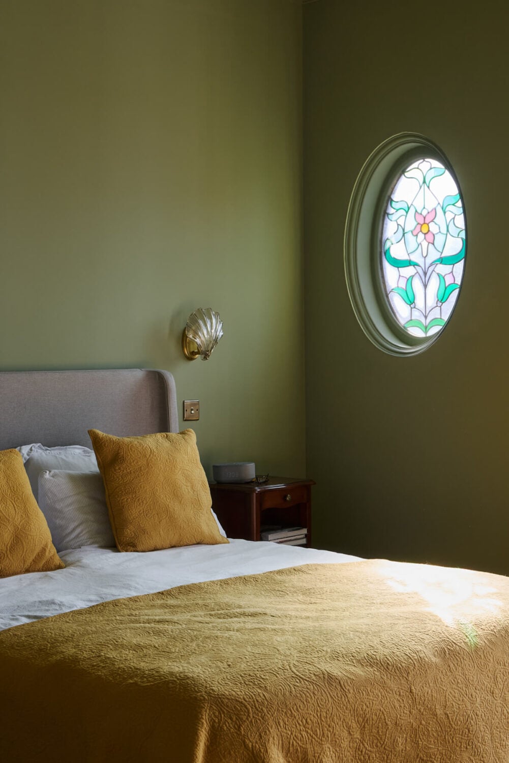 A Beautiful Extended Edwardian House Blends Period Features with Modern Design 18 green bedroom round stained glass window