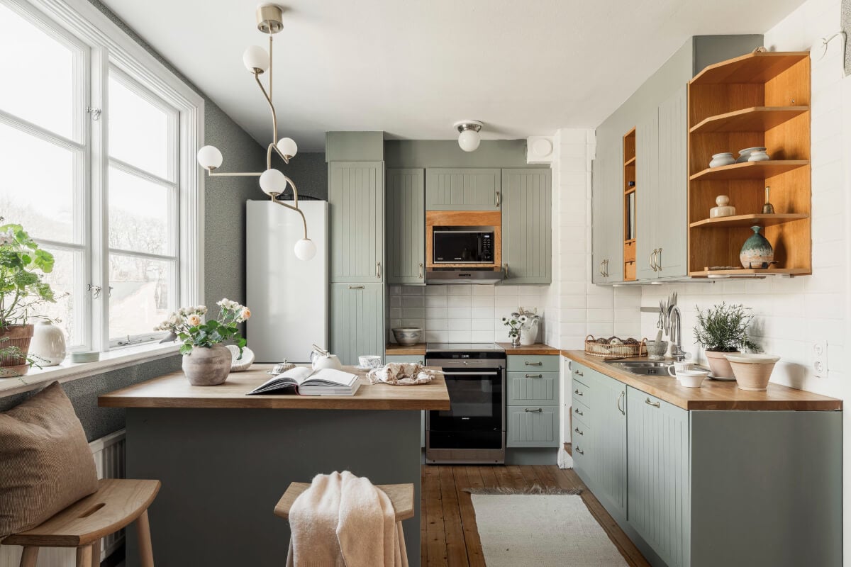 A Swedish Duplex Apartment Inspired by A Danish Summer House 22 green kitchen with island