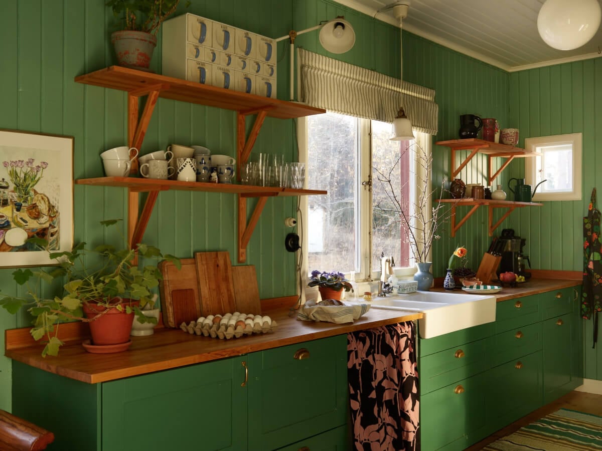 A Grand Family Home in a Former Swedish Doctor's Villa 15 green kitchen with shelves and butler sink