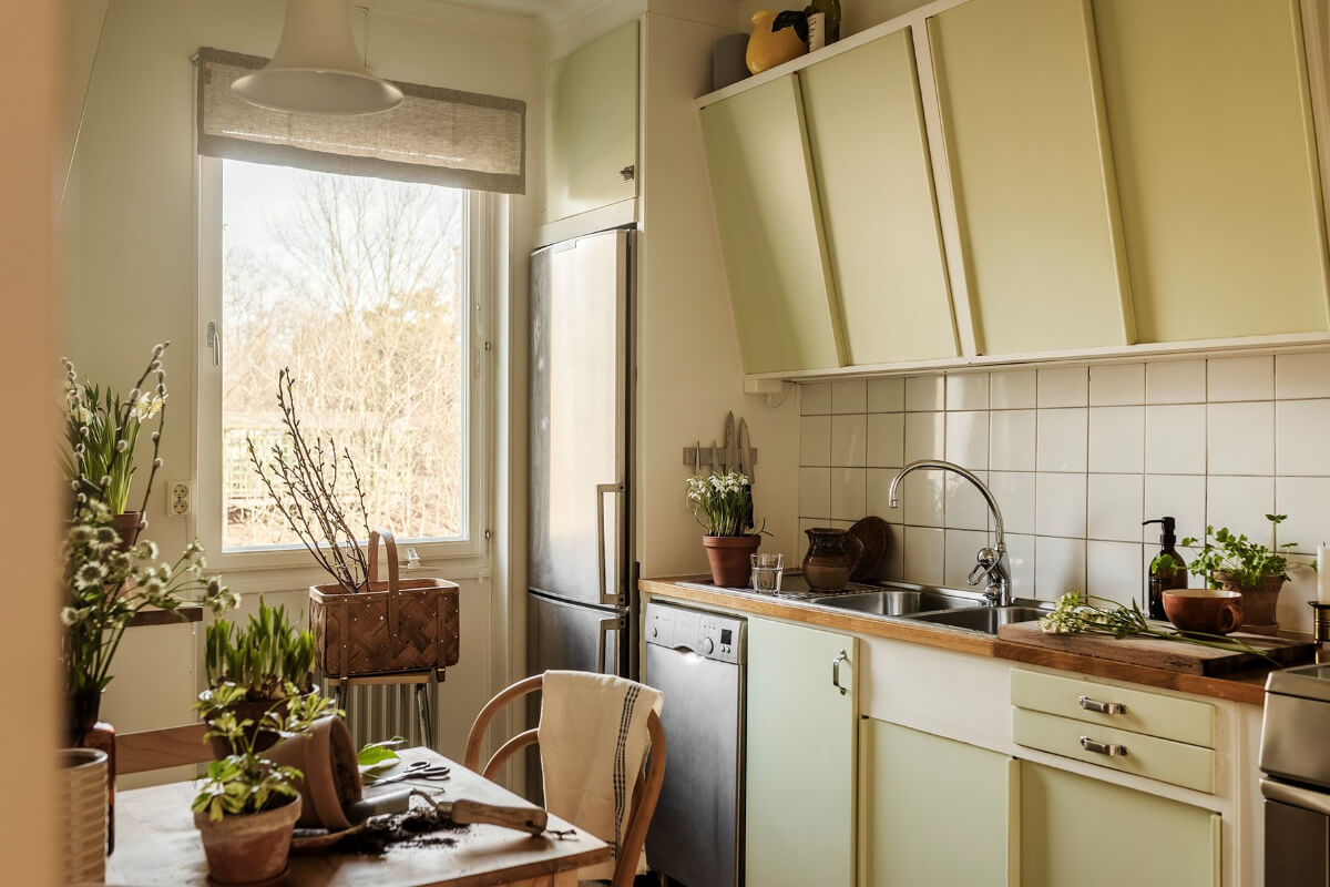 A Two-Bedroom Apartment with the Original Midcentury Kitchen 5 green slanted kitchen cabinets