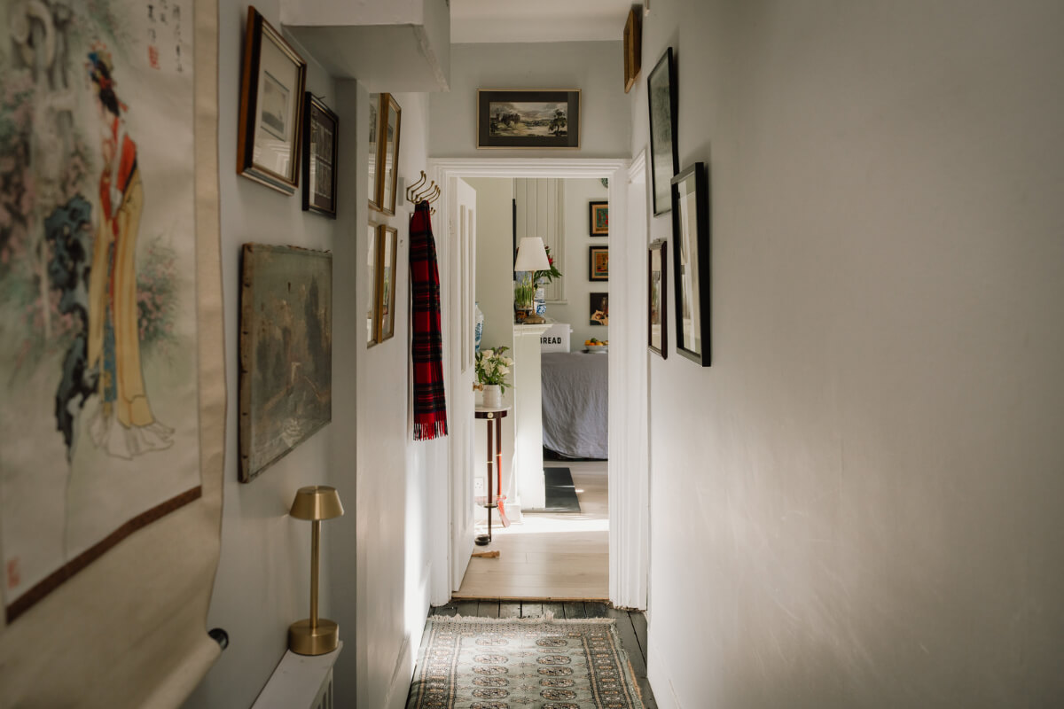 A Carefully Restored Edwardian Apartment with a Garden 9 hall lined with art