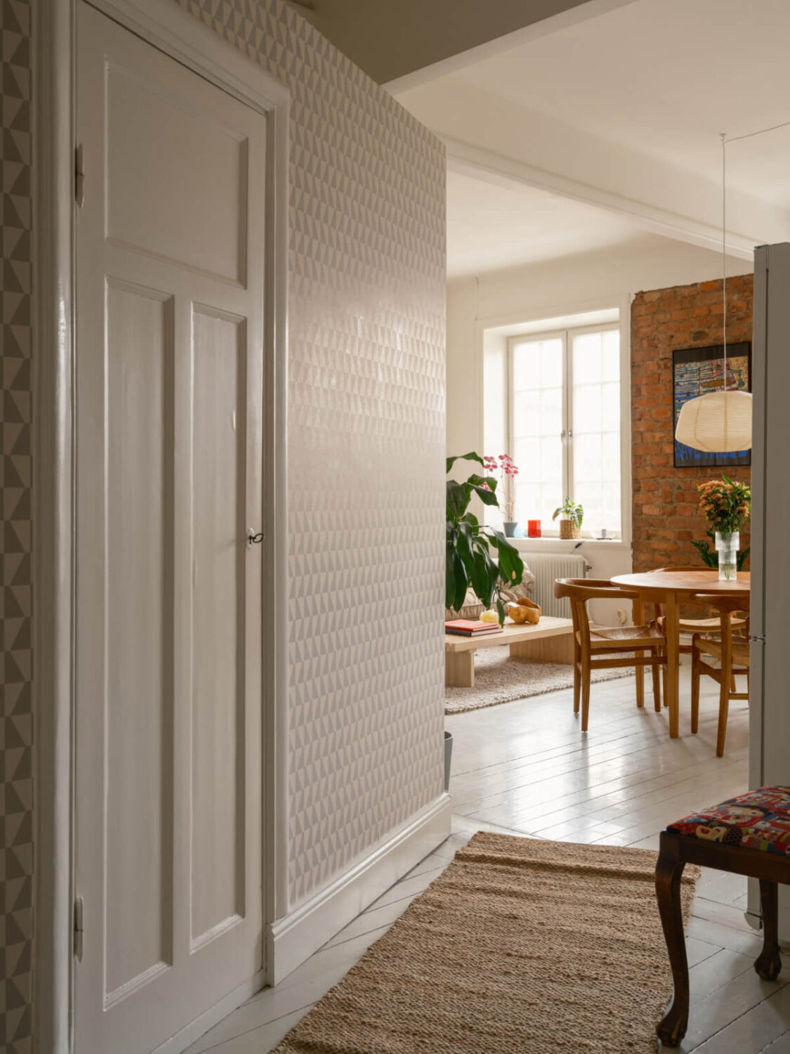 A Studio Apartment with an Exposed Brick Wall 14 hall with geometric wallpaper