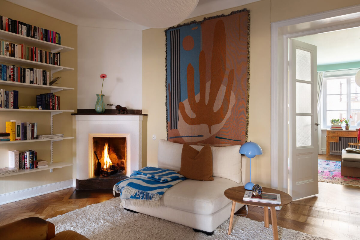 A Swedish Apartment with Period Features and Charming Color Pops 16 inner hall with pale yellow walls fireplace