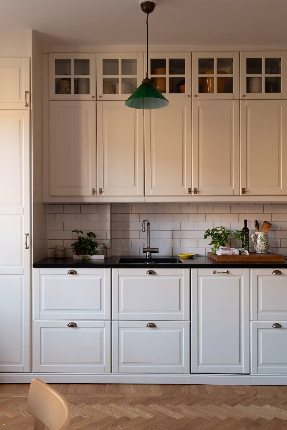A Swedish Apartment with Period Features and Charming Color Pops 9 kitchen extra high upper cabinets