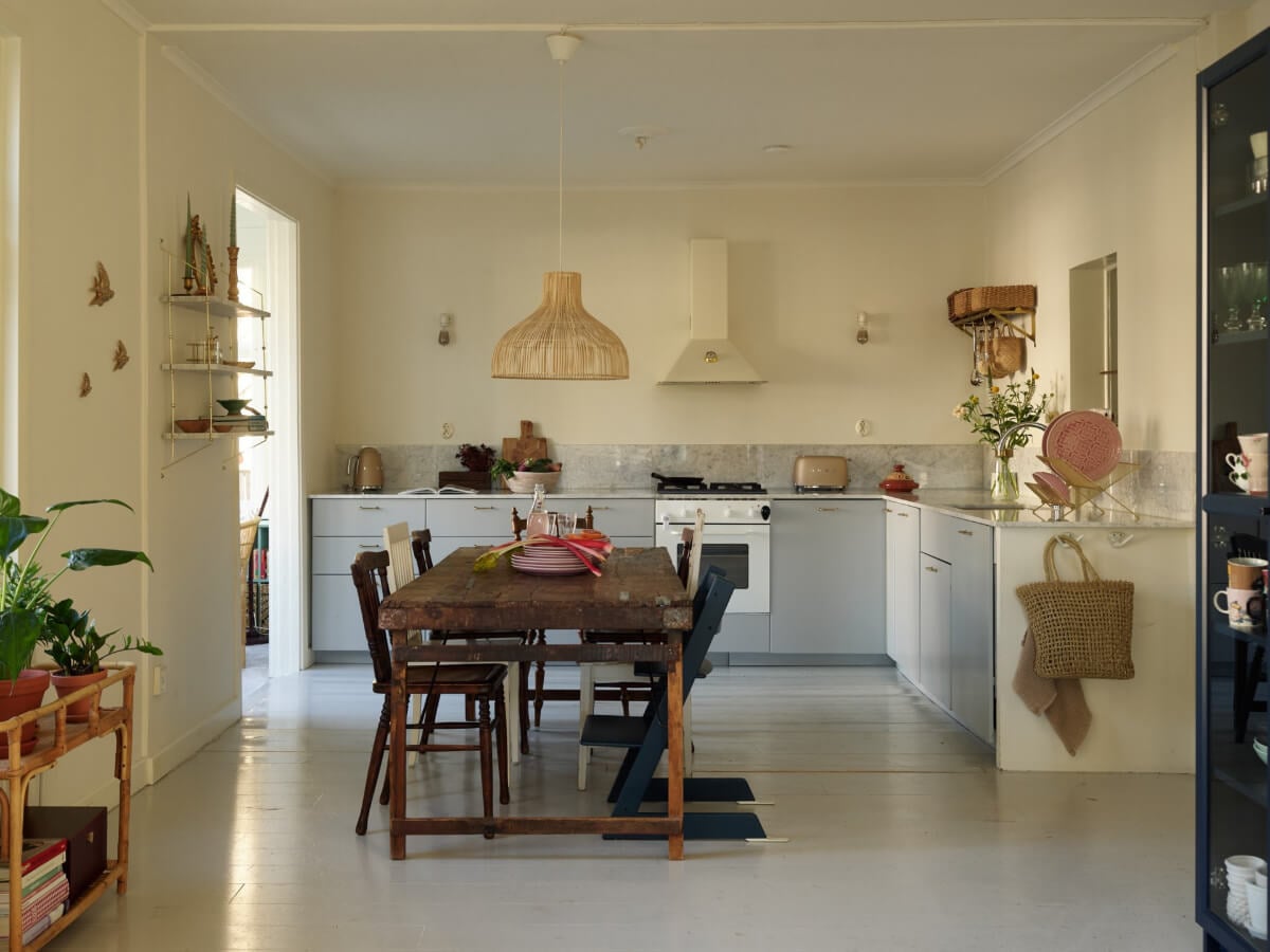 Light-Filled Rooms and a Charming Veranda in a Swedish Apartment 10 kitchen gray cabinets rustic wooden table