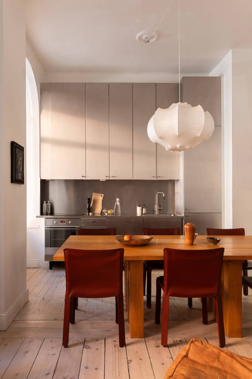 Arches and a Wall Mural in a Swedish Apartment 11 kitchen high upper cabinets