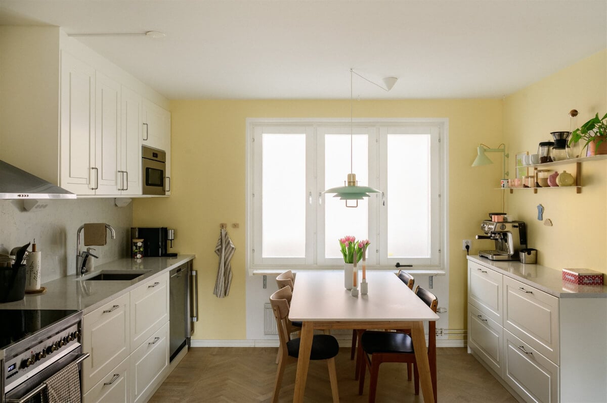 Colorful Rooms in a Bright Two-Bedroom Stockholm Apartment 12 kitchen pale yellow walls dining table