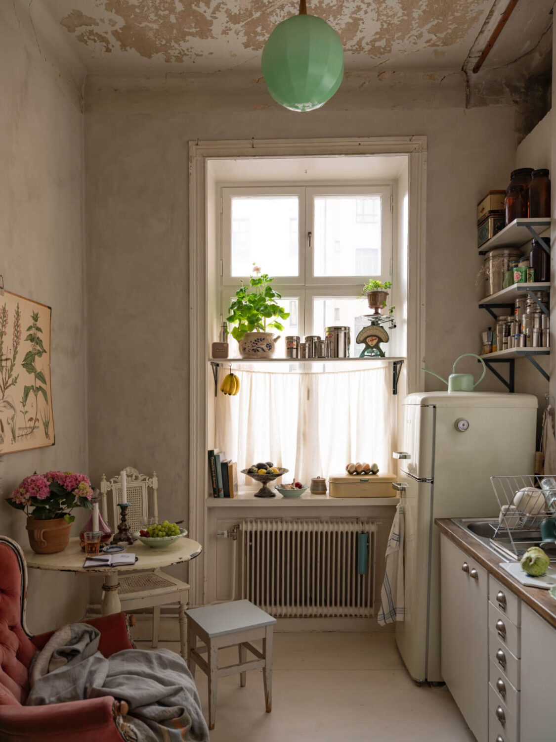 Time Has Stood Still in This Stockholm Studio Apartment 13 kitchen shelf in front of window small table