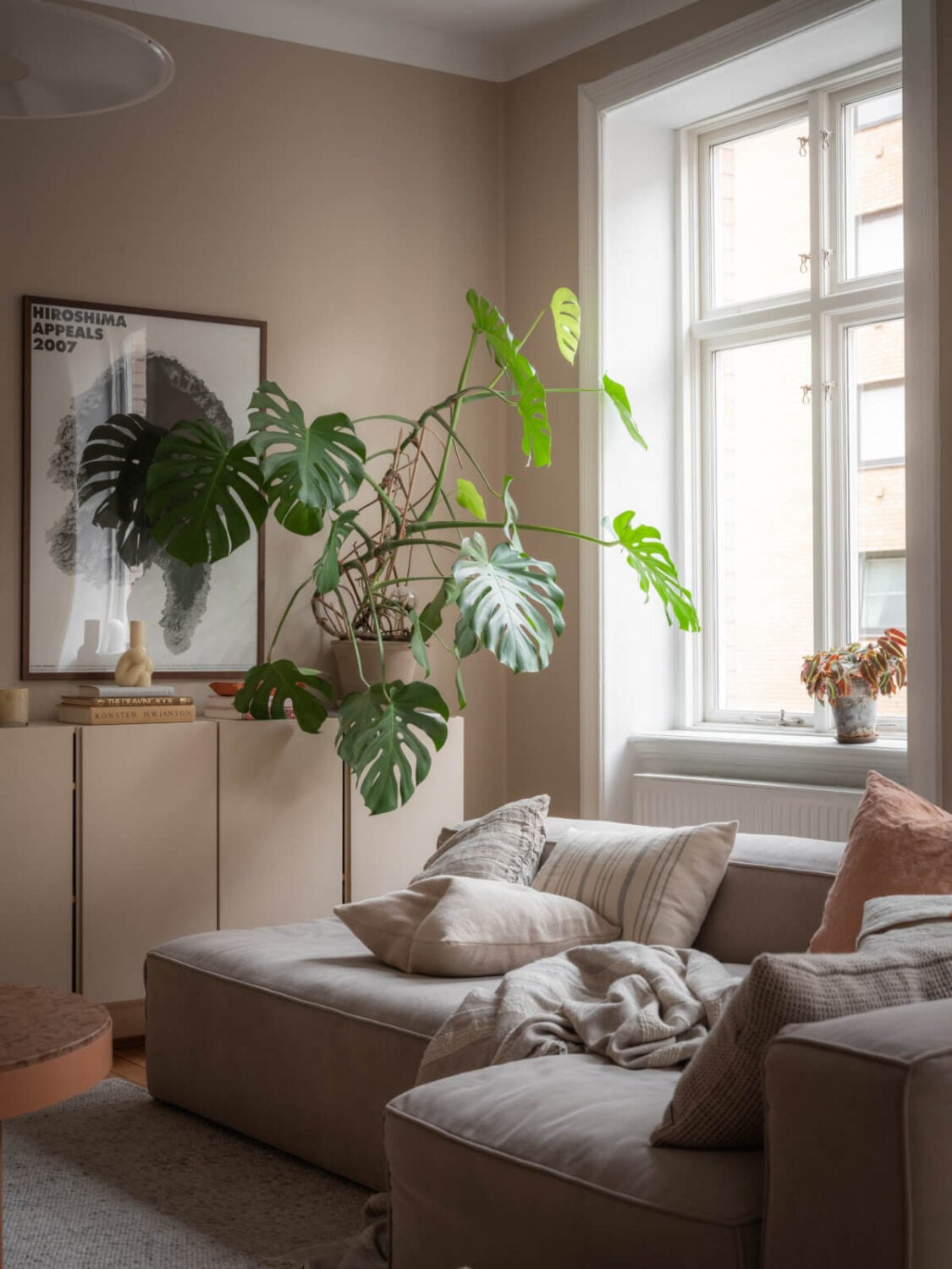 A Calm Color Palette in a Charming Swedish Apartment 4 large living room window