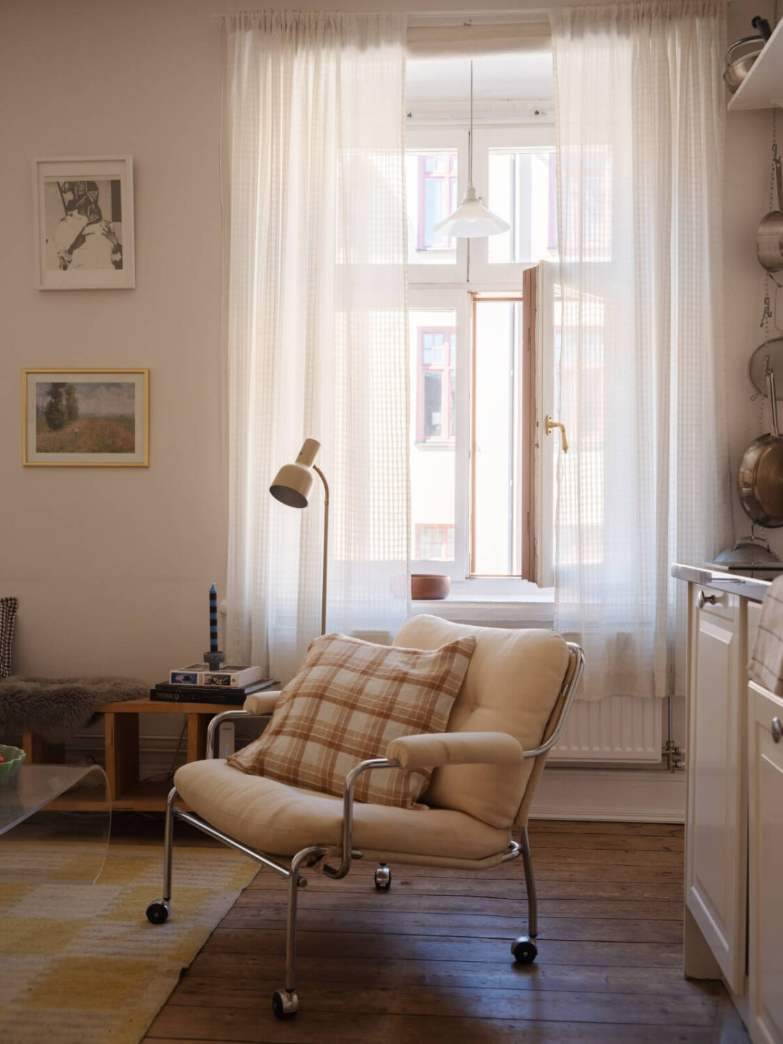 A Small Apartment with Rustic Floorboards and Beige Walls 5 large window open-plan living room kitchen